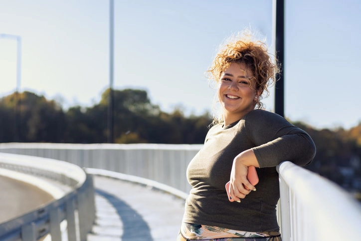 A healthy happy woman, enjoying her gained resilience from psychosocial recovery coaching.