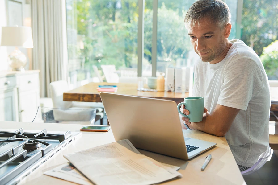 Man sitting on a desk in front of his recovery coach.