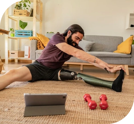 A man with a prosthetic leg, using a tablet for an online Rehabilitation Occupational Therapy