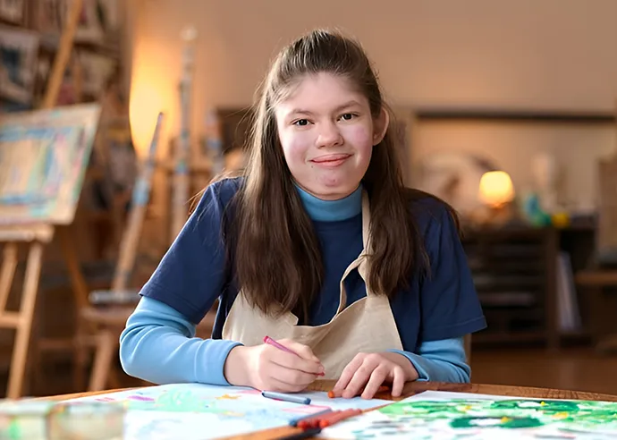 A young woman smiling, as she has recieved life changing ot support