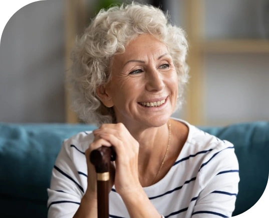 Older woman with walking stick who benefits from online support coordination